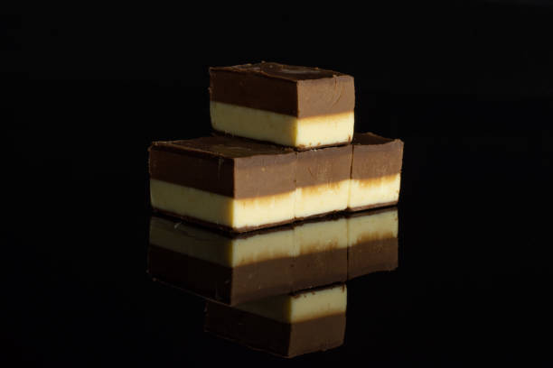 istock Two colours nougat isolated on black glass 1170586547