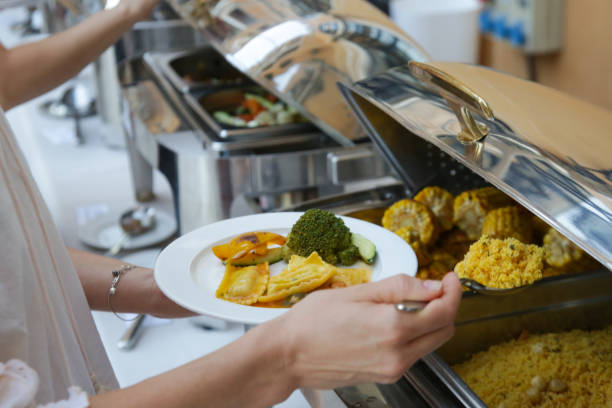 istock Woman taking food from a buffet line 1170590323