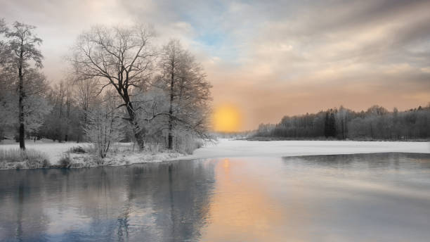 istock Winter landscape with sunset over river 1170591045