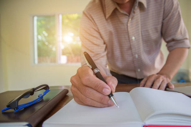 istock Businessman hand writing with document at work office.concept 1170591731