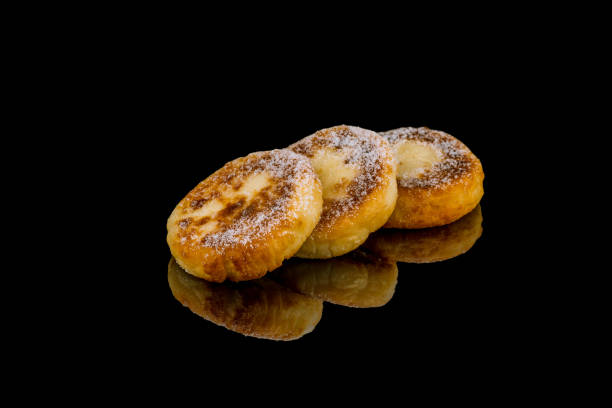 istock cheesecakes from cottage cheese on black glass with reflection 1170596509