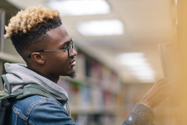 istock University Male of African Descent finding a book 1170598210