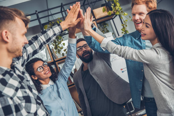 istock Startupers working at office together standing giving high five success 1170598437