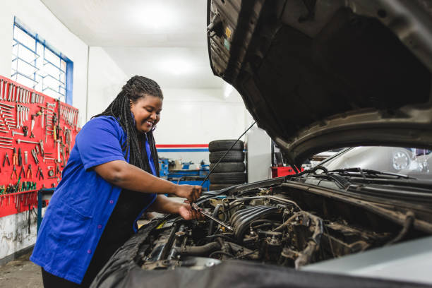 istock Woman mechanic working on a car engine 1170599784