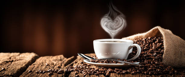 hot coffee with heart shaped steam - cup of coffee beans imagens e fotografias de stock