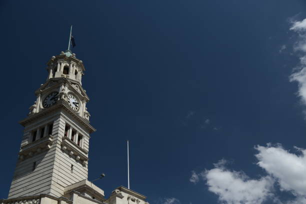 The clock tower of the Auckland town hall with the sky.