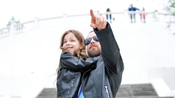 istock Dad and daughter walk around the city 1170615521