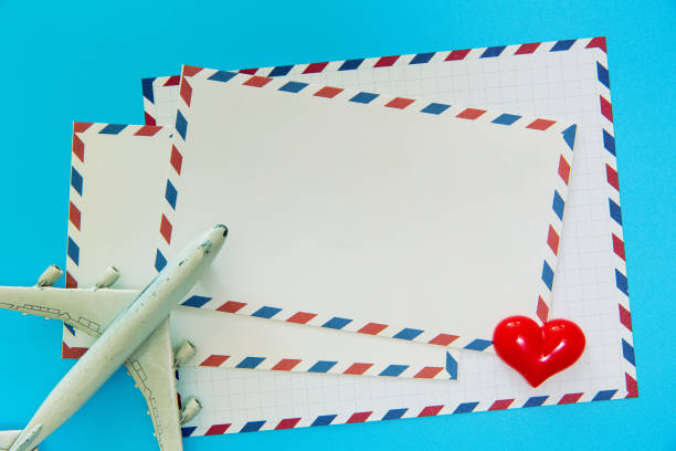 istock (Travel concept) Air mail envelope，model plane and heart shape on wood background 1170616601