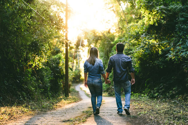 istock Couple walking down the nature park road 1170616640