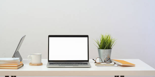 istock Minimal home-office with open blank screen laptop computer and office supplies 1170616717