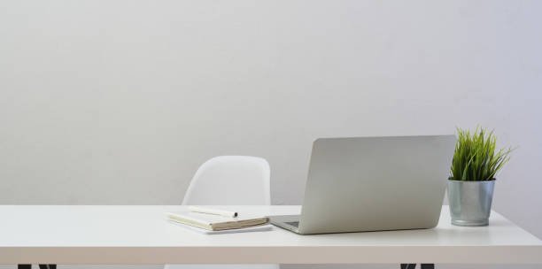 istock Minimal workplace with laptop computer and decorations on white wooden table 1170616782