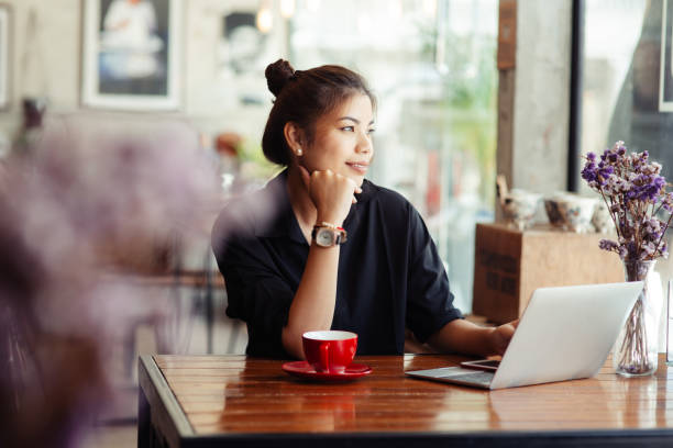 istock Asian woman working in cafe and looking out window. 1170617532