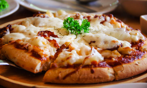 istock Tasty pizza on wood tray 1170618140