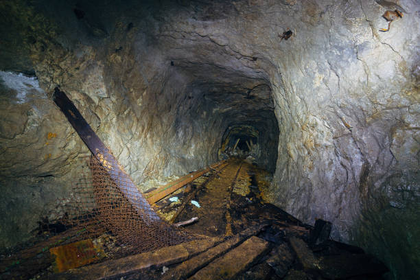 istock Dark dirty abandoned uranium mine with rusty remnants of railway 1170619033