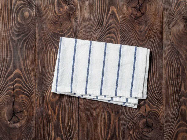 istock linen napkin on wooden table, top view, mock up 1170622629