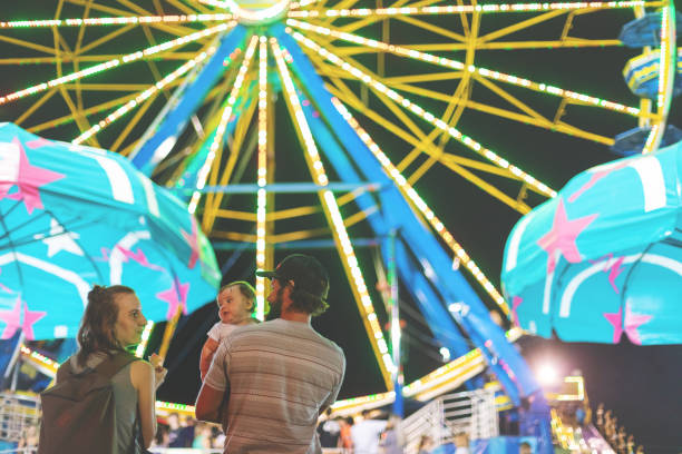 istock Young Millennial family enjoying their time at the Empire State Fair in Springfield MO on a hot July summer night 1170623708