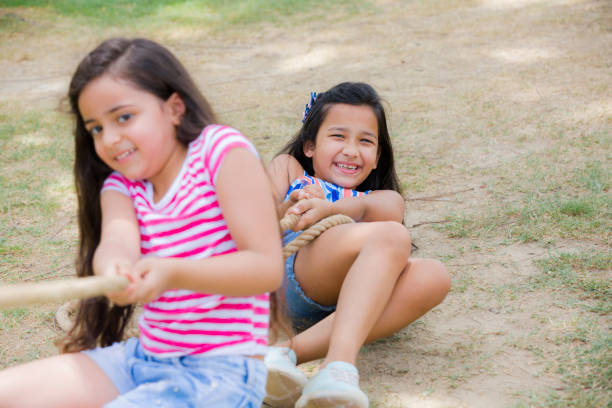 istock Kids pulling the rope - stock photo 1170629007