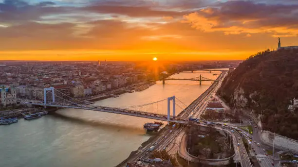 Budapest, Hungary - Golden sunrise over Budapest, with heavy morning traffic, Elisabeth Bridge, Liberty Bridge and Statue of Liberty
