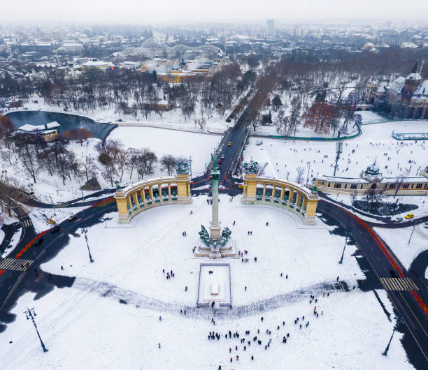 Budapest, Hungary - Snowy Heroes' Square and Millennium Monument from above on a cold winter day with City Park, Szechenyi Thermal Bath and ice rink at background stock photo