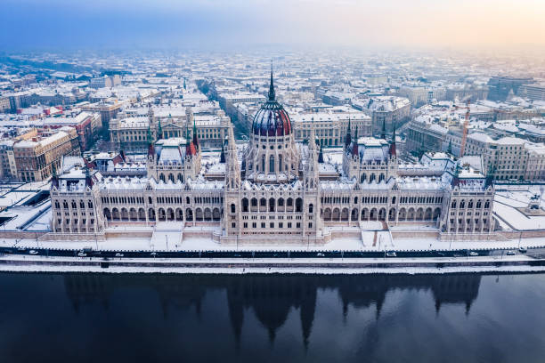 Budapest, Hungary - Aerial view of the beautiful snowy Parliament of Hungary and skyline of Pest at winter time stock photo