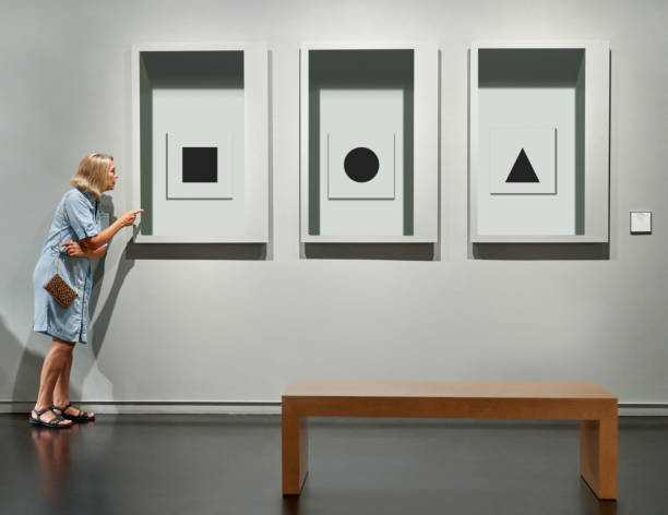 istock visitor looking pictures in art gallery museum 1170631813