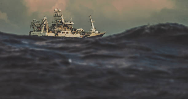 istock Fishing boat trawler sailing out at rough sea 1170633659