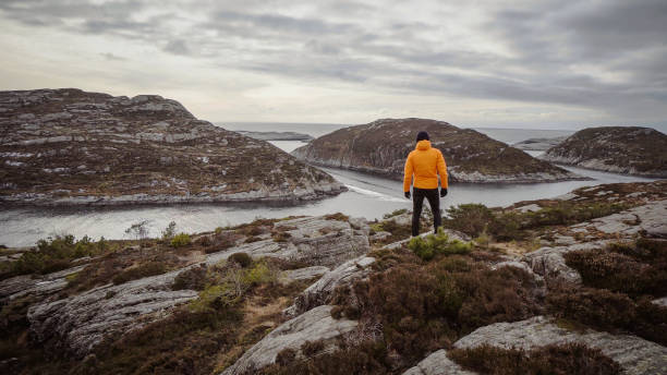 man travel adventures: mountain hiking in norway - rock norway courage mountain imagens e fotografias de stock