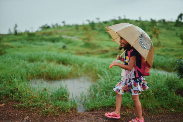 Preschool age (4-5 years) walking with an umbrella