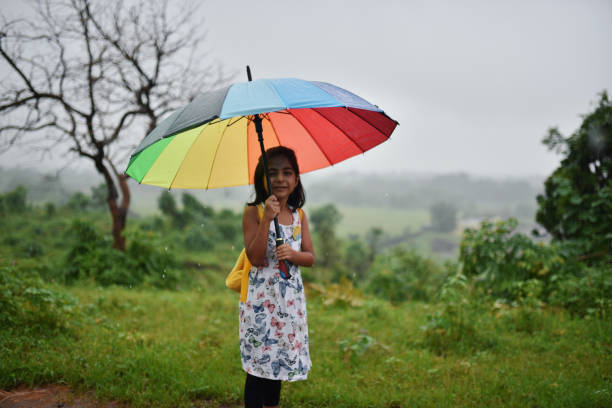 istock Girl with an umbrella in rain 1170636774