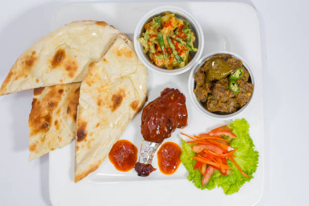 istock Achary Beef Curry, BBQ Chicken, Indian Style mix vegetable, plain nan and Green Salad Platter. 1170638088