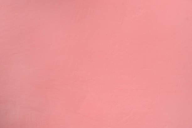 istock A wall with rough texture of plaster unevenly painted in pink 1170639680