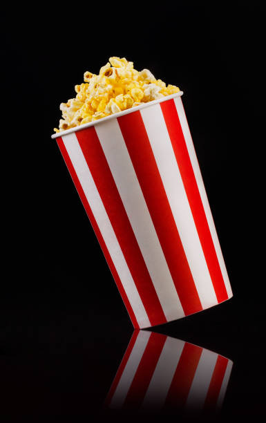 istock Paper striped bucket with popcorn isolated on black background 1170640305