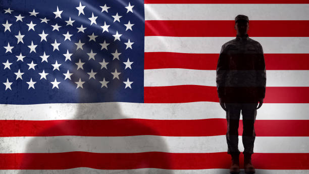 istock American soldier silhouette standing against national flag, proud army sergeant 1170641463