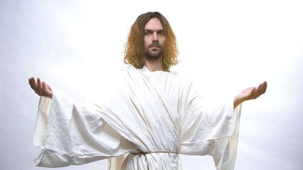 istock Good God in white robe looking at camera, raising hands to give hope, blessing 1170641558