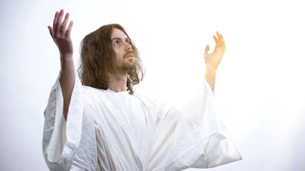 istock Saint man in robe raising hands to light, praying to God, religious conversion 1170641632