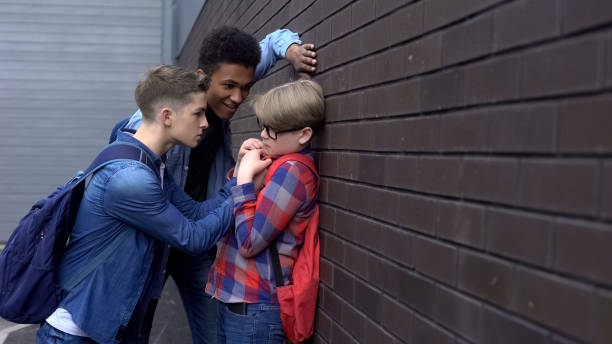 istock Aggressive students bullying classmate in school backyard, children rights 1170641697