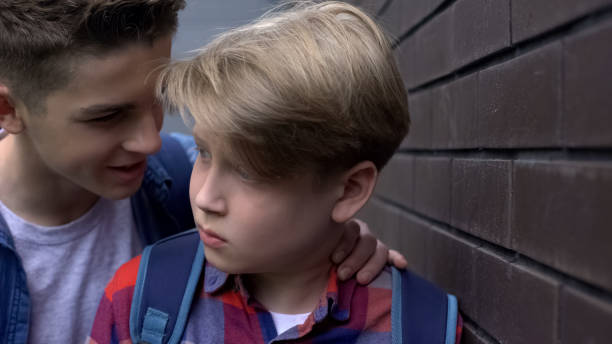 istock Cruel teenage boy threatening depressed student, verbal abuse, intimidation 1170641733