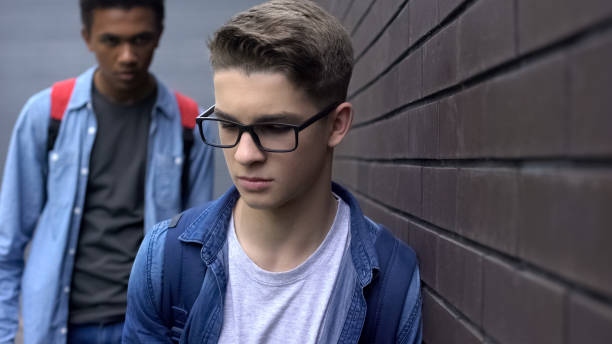 istock Afro-american student chasing nerd, threatening physical harm, school bullying 1170641761