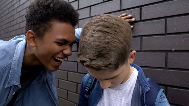 istock Cruel african american student teasing weak boy, psychological abuse, threat 1170641836