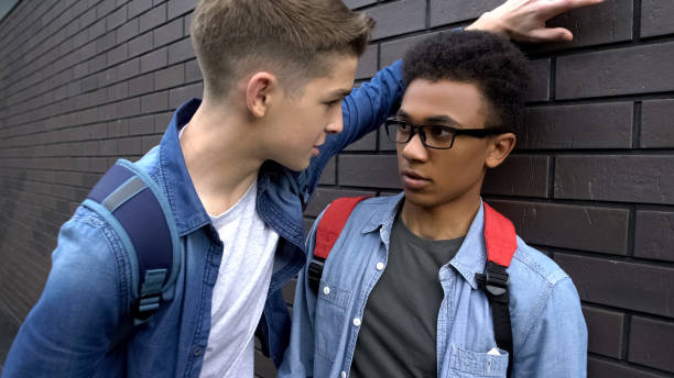 Bully student threatening black boy, psychological abuse, racial discrimination