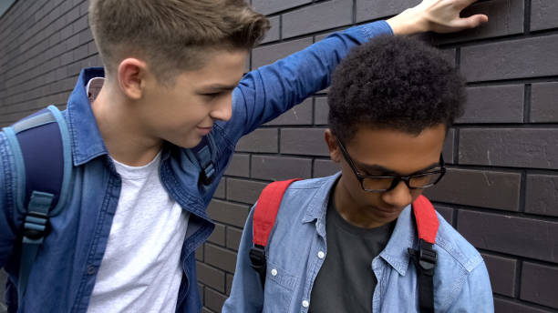 istock Arrogant boy mocking african american student, verbal abuse, discrimination 1170641891