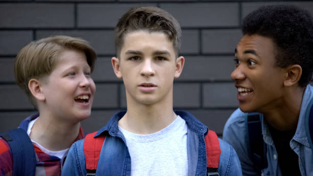 Student boldly looking into camera, resisting verbal bullying of classmates