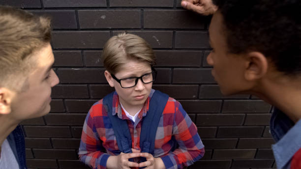 istock Senior schoolboys bullying younger student, mocking nerd, mental pressure 1170641912
