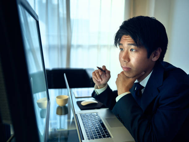 istock Young businessman thinking about business strategy in front of computer 1170642071