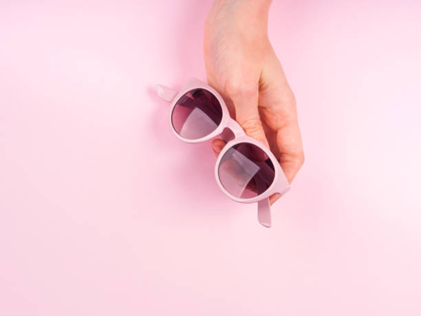 istock Pink sunglasses in woman's hand 1170642972