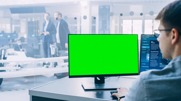 istock Professional Engineer Works on a Computer with Green Screen Mock-up Template. Electric Car Chassis Prototype with Batteries and Engine Standing in a High Tech Development Laboratory. 1170643070