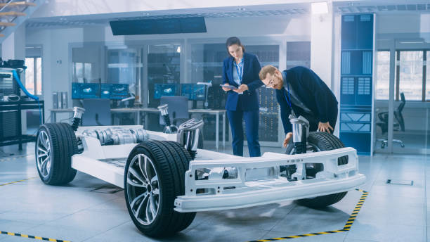 istock Automotive Design Engineers Working on Electric Car Chassis Prototype. In Innovation Laboratory Facility Concept Vehicle Frame Includes Wheels, Suspension, Engine and Battery. 1170643073