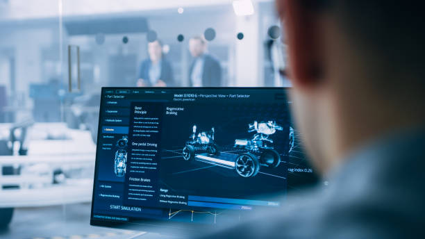 istock Professional Engineer Works on a Computer with a 3D CAD Software and Tests the Electric Car Chassis Prototype with Wheels, Batteries and Engine Standing in a High Tech Development Laboratory. 1170643163