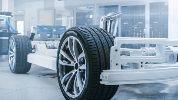 istock Concept of Authentic Electric Car Platform Chassis Prototype Standing in High Tech Industrial Machinery Design Laboratory. Hybrid Frame include Tires, Suspension, Engine and Battery. 1170643170