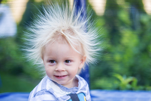 Cute Little Boy With Static Electric Hair Having His Funny Portrait Taken  Outdoors Stock Photo - Download Image Now - iStock